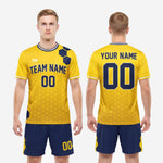 Custom yellow soccer uniform shorts detail showing athletic gold hex badge and player number on navy leg