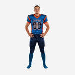 Custom youth American football uniforms in royal blue and orange - front view showing team name, chest number, V-neck collar, and navy pants with orange geometric side panel