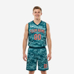 Custom youth basketball uniforms in teal digital camouflage with coral arched team name and front number, V-neck sleeveless jersey and matching shorts full set front view