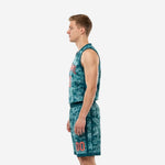 Opposite side view of teal camo custom youth basketball uniform set showing jersey drape and shorts side stripe panel detail