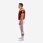 custom maroon and gold youth American football uniform left side view showing gold side panel V-neck binding and full-length white pants