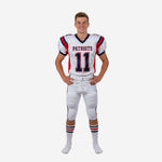 Custom youth football uniform sets in white with red and navy sublimated shoulder panels, front number 11, team name on chest, and matching pant with side stripe