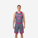 Custom youth reversible basketball uniforms in grey with pink topographic pattern trim, team name arced on chest and number 00 front and on shorts