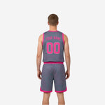 Side view of grey custom youth reversible basketball uniform showing flat armhole binding and wide leg opening on matching shorts