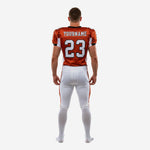 Back view of custom orange and white youth tackle football uniform showing back number placement and nameplate area for player name