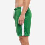 Dark green soccer shorts with white vertical side panel and elastic drawcord waistband, left side view on male model