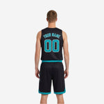 Side view of black and teal reversible basketball uniform showing diagonal stripe panel and armhole binding detail on the black base jersey side