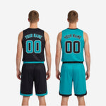 Detail view of reversible basketball shorts showing X-mark sublimated graphic on left thigh and contrast teal hem trim on the black side