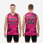 Back view of sublimated digital camo basketball jerseys in pink and maroon showing back number placement and full pixel camo pattern coverage