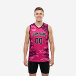 Custom digital camo basketball jerseys in hot pink and dark maroon pixel pattern showing front view with team name arc and number 00 on adult male model