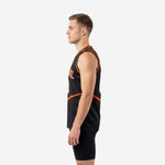 Side view of custom black and orange sublimated basketball jersey showing diagonal orange stripe and side vent at the hip