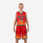 Custom kids basketball uniforms in red and black with photorealistic flame graphic sublimated at the jersey hem and matching shorts hem, front view