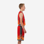 Side view of red and black custom kids basketball uniforms showing black V-neck binding, white accent side stripe, and flame graphic at the jersey and shorts hem