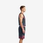 Charcoal and red custom basketball jersey and shorts set showing flame sublimation pattern, red halftone fade on shorts hem, full set front view
