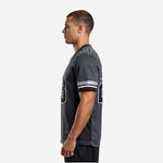 Side view of sublimated charcoal football jersey showing set-in short sleeve and striped cuff detail