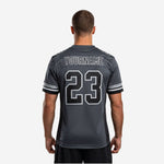 Right-side view of charcoal and black football jersey for schools showing shoulder panel and sleeve number