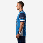 Side view of blue and navy custom football jersey showing raglan shoulder panel white side panel and three-stripe sleeve cuff detail
