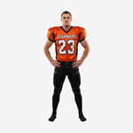 Custom football uniforms for leagues in orange and black with V-neck jersey showing team name and number 23 on chest and matching black pants with orange side stripe
