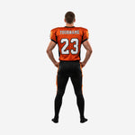 Opposite side view of custom orange and black football uniforms for leagues showing jersey side panel detail and orange pant stripe on full-length black football pants