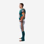 Side view of teal and orange football uniform for leagues showing orange side panel on jersey and vertical orange-and-white stripe on white tackle pants