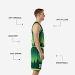 Detail view of lime green hem binding on forest green basketball shorts with pine tree silhouette graphic and front number