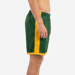 Forest green soccer shorts showing Athletic Gold full-length contrast side panel, left side view on adult male model