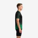 Green soccer training jersey side view showing botanical leaf sublimation print on short sleeve and kelly green gradient rising from hem