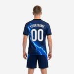 Close-up of custom blue soccer uniform jersey showing electric blue lightning bolt sublimation detail and V-neck black trim