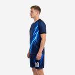 Navy blue soccer uniform kit with full-dye electric blue lightning print, right side view on men's model