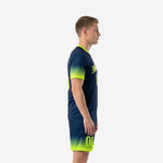 Custom men's soccer uniforms in Navy Blue with Neon Yellow gradient, left side view showing sleeve cuff and shorts hem gradient detail