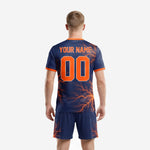 Close detail of orange lightning bolt sublimation print on navy blue custom men's soccer jersey