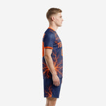 Custom men's soccer uniforms navy blue and orange sublimated lightning print, left side view showing sleeve and shorts detail