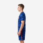 Close-up of full-dye sublimated number print on Royal Blue camo men's soccer uniform showing white and coral-orange outline detail