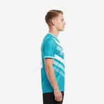 Custom soccer tops in teal and white, left side view showing chevron sublimation print on short sleeve jersey