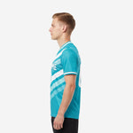 Men's custom soccer jersey in teal and white geometric chevron, right side view showing sleeve trim detail