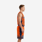 Custom orange and navy basketball uniform set with arched team name on chest and matching shorts with lightning bolt side panels, male model front view