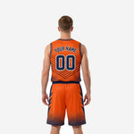 Opposite side view of orange and navy sublimated basketball jersey and shorts set showing hexagonal halftone fade on the shorts hem and jersey side panel