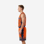 Side view of orange and navy full sublimation basketball uniform showing diagonal chevron stripe jersey and jagged spike shorts side panel detail