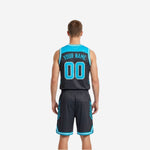 Side view of charcoal sublimated reversible basketball jersey showing diagonal slash accent panels and white armhole binding on the dark side