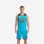 Reverse side of full sublimation reversible basketball uniforms showing cyan body with charcoal yoke, arced team name, front number, and matching cyan shorts with charcoal number