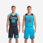 Close detail of V-neck binding and diagonal slash sublimated accents on the charcoal and cyan reversible basketball uniform set