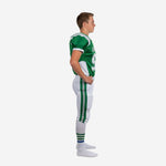 Custom full sublimation youth football uniforms green and white showing front number placement, curved white side panels, and V-neck jersey on youth football model