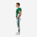 Full sublimation youth football uniforms side profile showing white curved jersey side panel, single green vertical outer-leg stripe on white pants, and lace-tie waistband closure