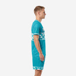 Custom teal soccer team uniform set side view showing geometric triangle band across jersey midsection and shorts hem