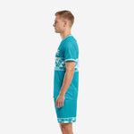 Men's teal and white soccer team uniform set right side profile showing athletic cut jersey and matching geometric band shorts