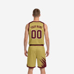 Side view of the gold reversible side showing maroon brush-stroke shoulder panels, maroon V-neck trim, and gold shorts with maroon hem band