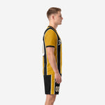 Gold and black soccer kit side view showing vertical pinstripe panels and matching shorts