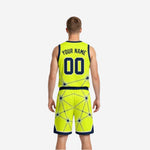 Side view of gold and navy reversible basketball uniform showing neon gold base with navy geometric star-burst pattern and navy trim hem