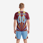 Chest detail of custom maroon men's soccer team uniforms showing team name and number printed at the sunburst focal point with gold trim crew neck