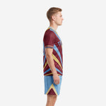Left side view of custom men's soccer team uniforms showing maroon sunburst jersey and powder blue shorts with gold chevron panel